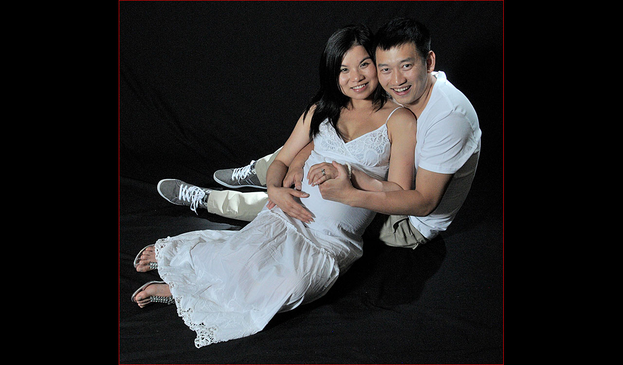 Pregnet Asian couple sitting