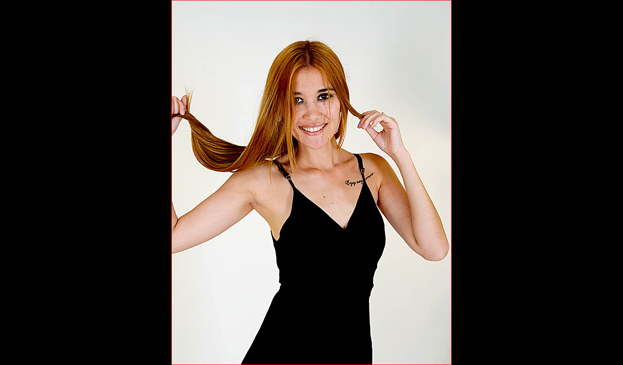 Sexy model with dark hair wearing black dress