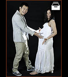 Pregnant couple wearing white, full length shot