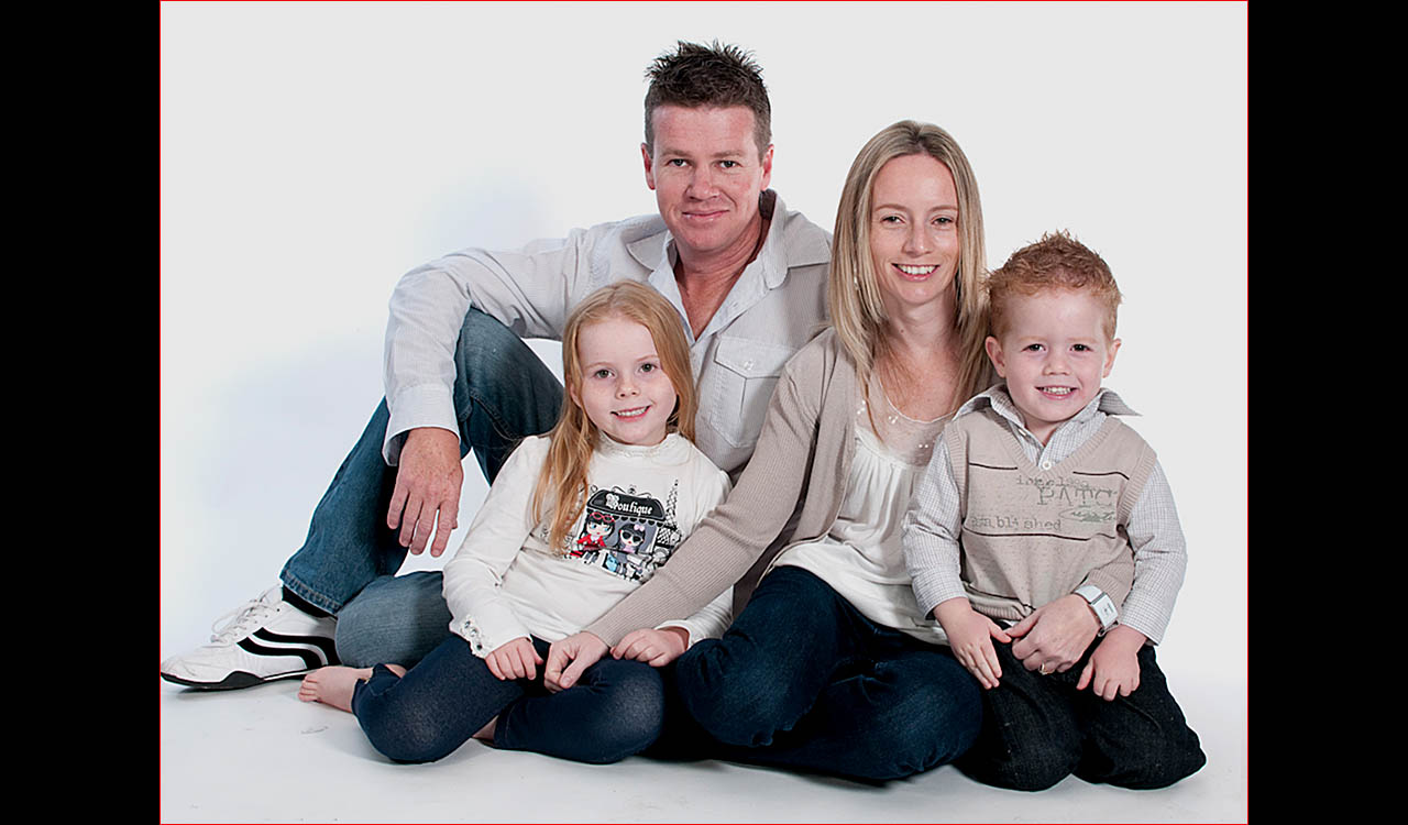 Family of four sitting on floor