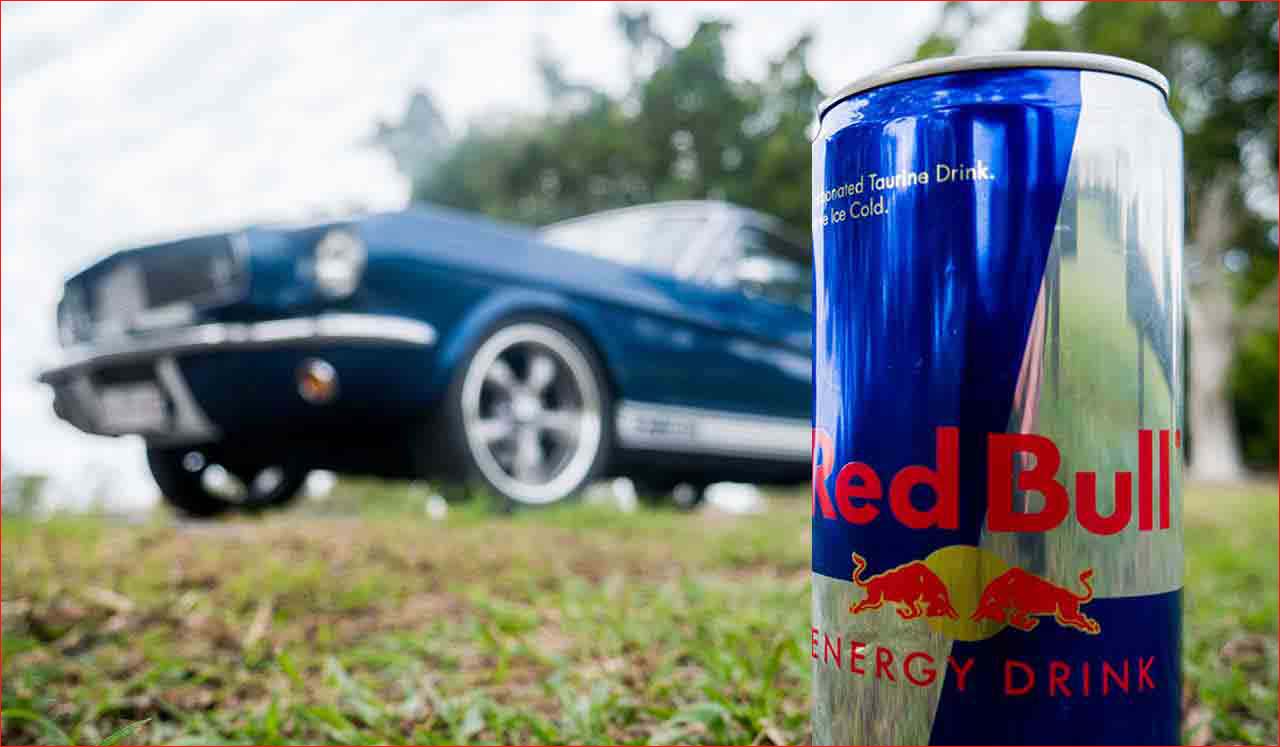 Red Bull promotional photo featuring Blue Shelby 1965 Mustang Fastback in background