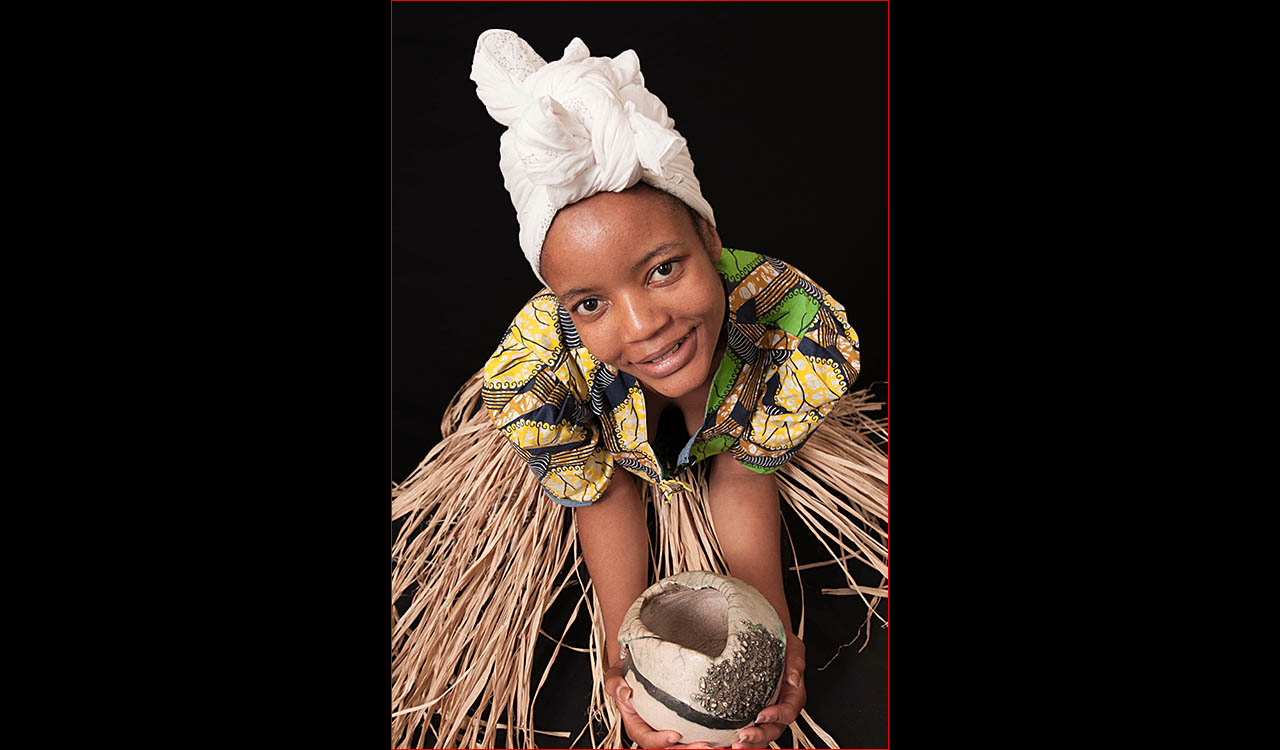 Simbi model holding pottery bowl